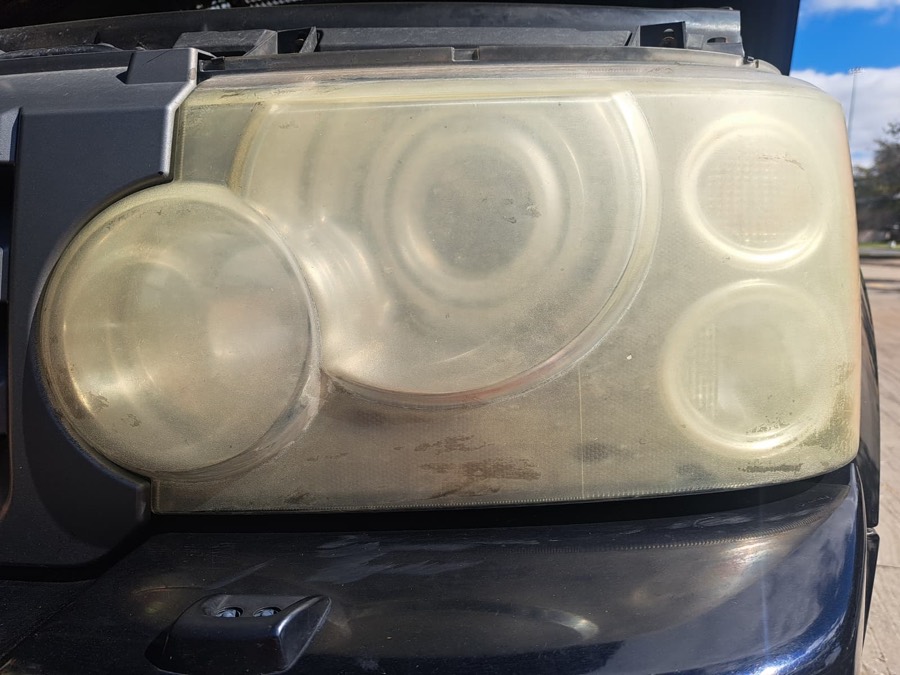 Severely yellowed truck headlight before restoration