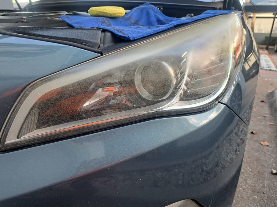 Sedan headlight before restoration, hazy and oxidized